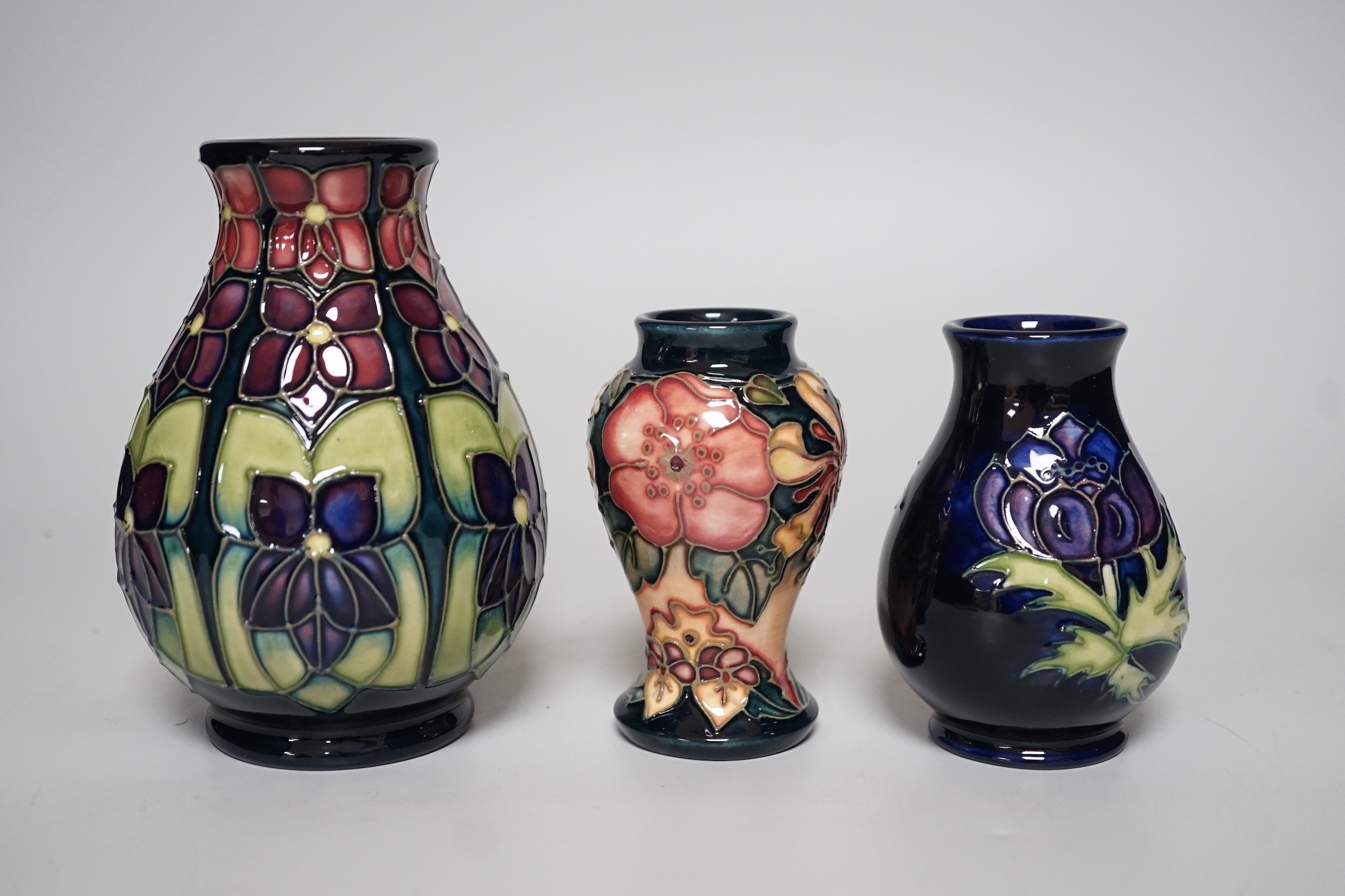 Three boxed Moorcroft vases of varying shapes, tallest 14cms high